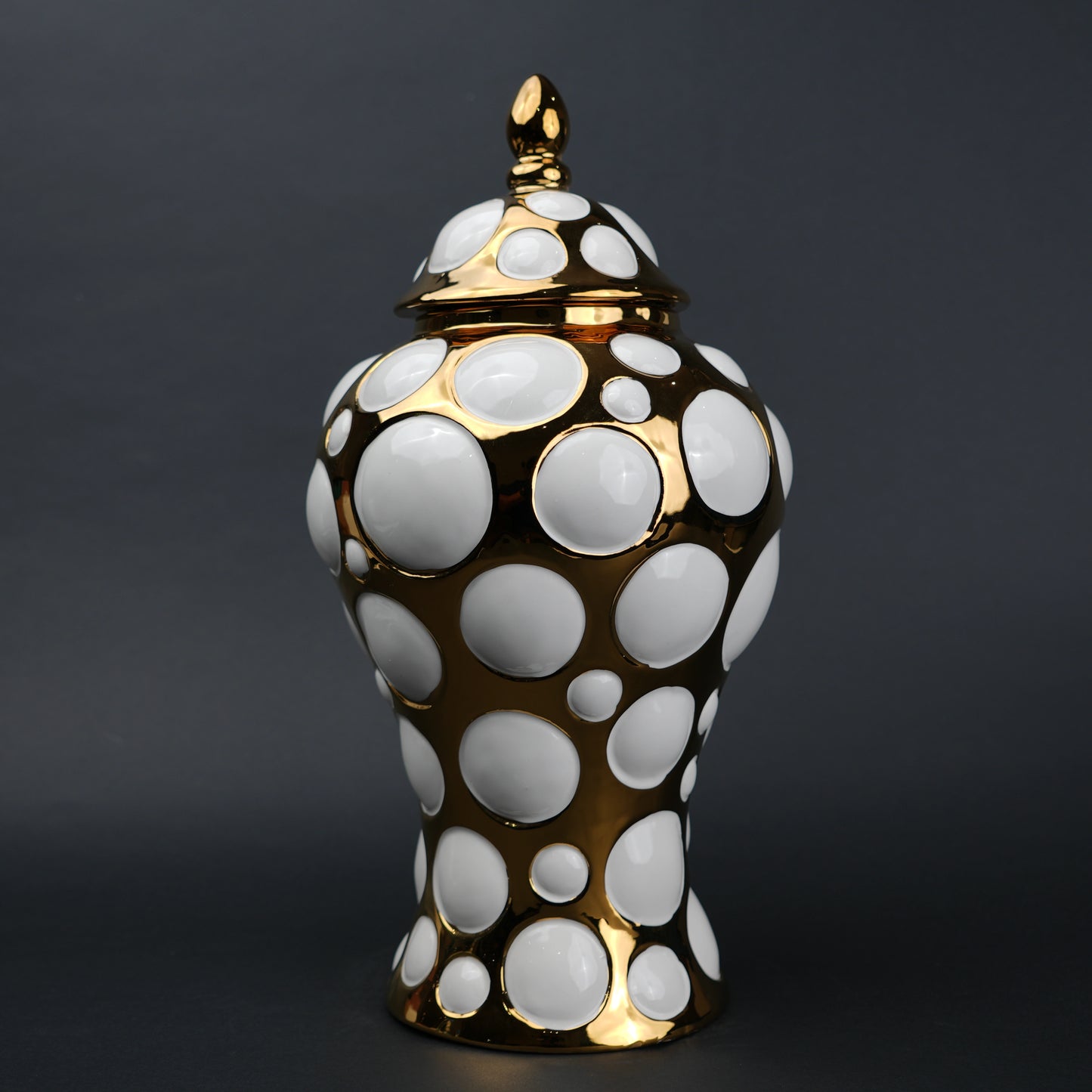 Gold ceramic decorative jar with circular orbit pattern and lid