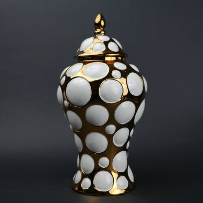 Gold ceramic decorative jar with circular orbit pattern and lid