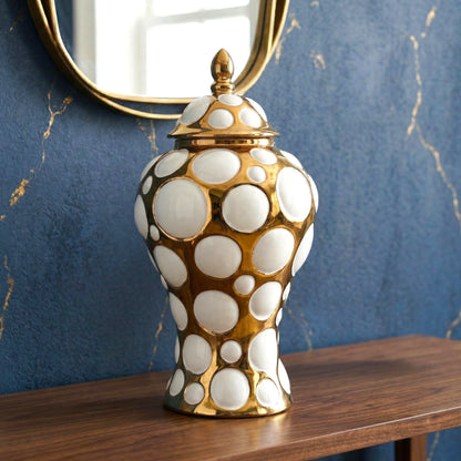 Gilded orbit jar on blue wall w/ brass mirror