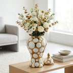 Gilded orbit jar w/ roses on coffee table