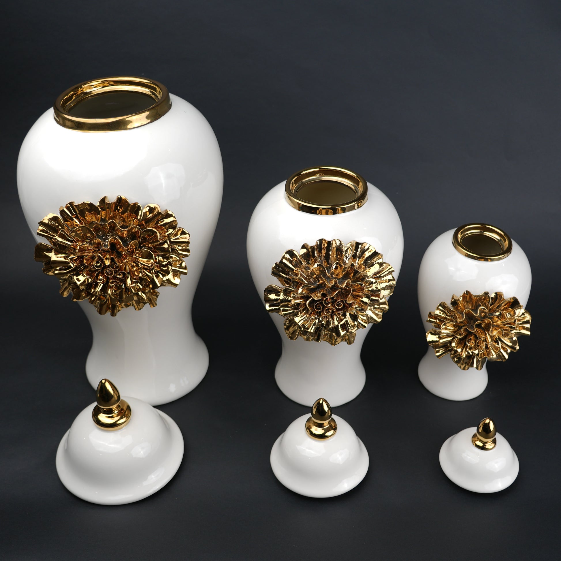 White ceramic decorative jar with gold sculpted floral design and lid