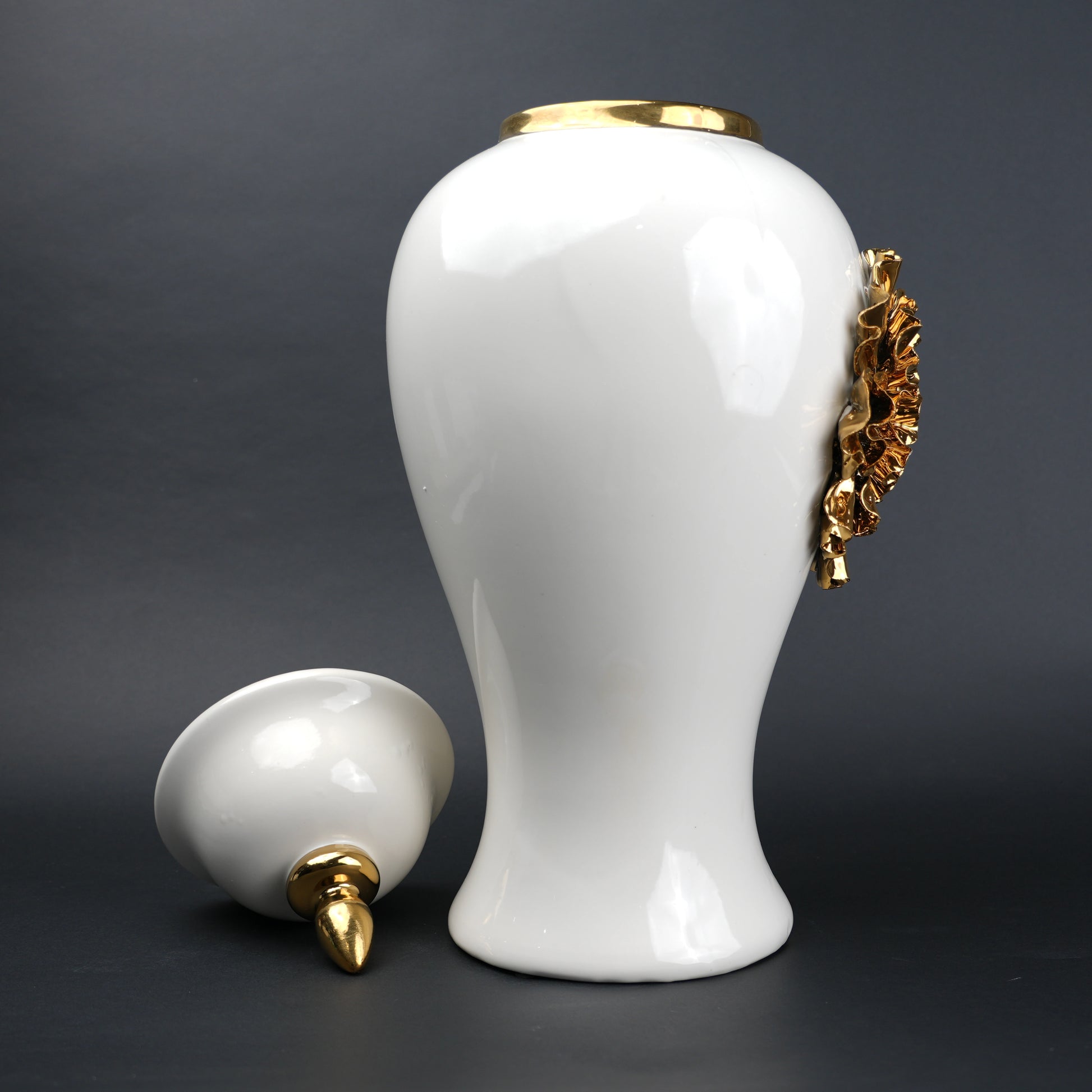 White ceramic decorative jar with gold sculpted floral design and lid