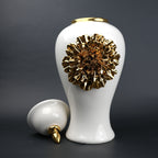 White ceramic decorative jar with gold sculpted floral design and lid