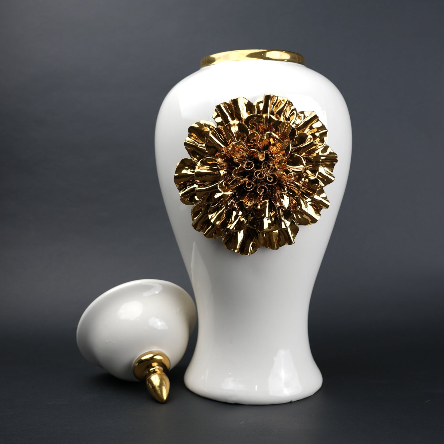 White ceramic decorative jar with gold sculpted floral design and lid
