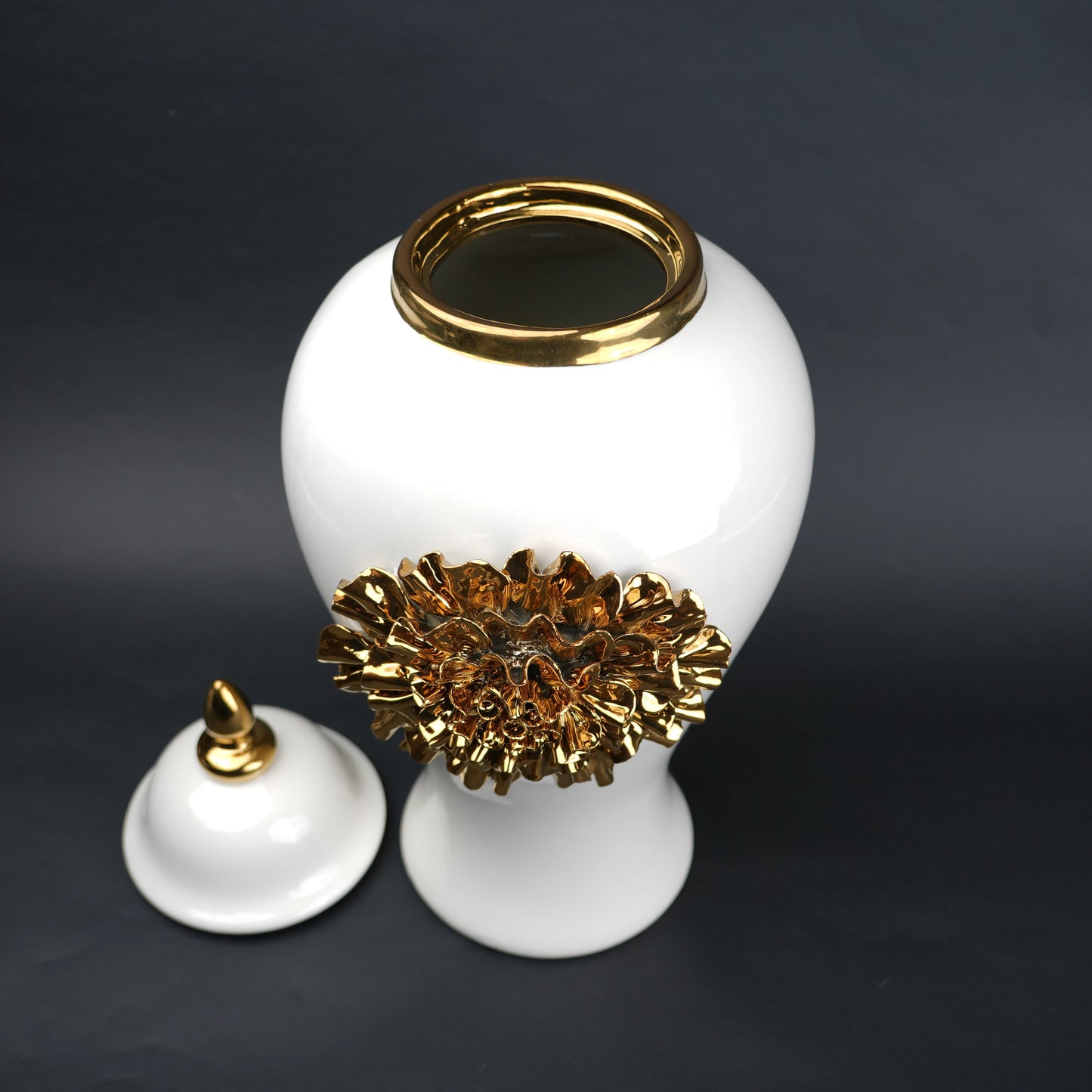 White ceramic decorative jar with gold sculpted floral design and lid