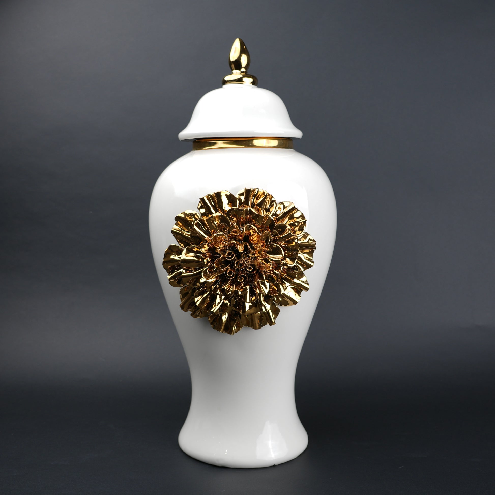 White ceramic decorative jar with gold sculpted floral design and lid