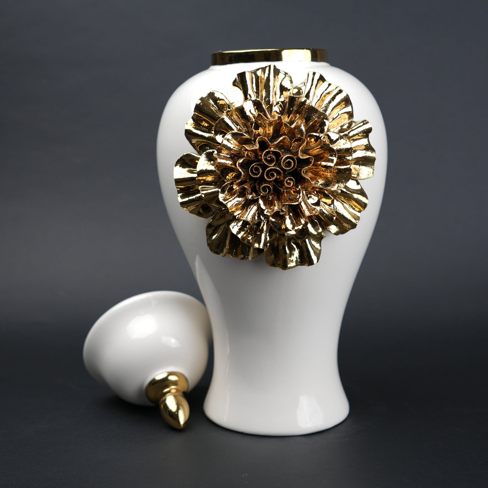 White ceramic decorative jar with gold sculpted floral design and lid