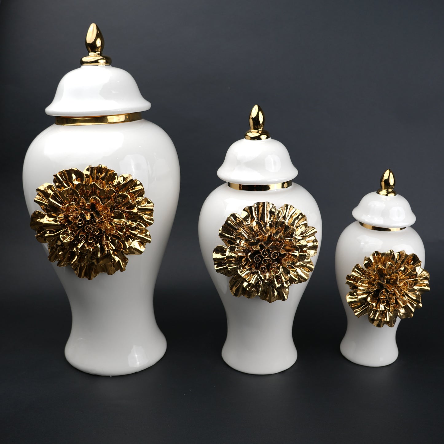 White ceramic decorative jar with gold sculpted floral design and lid