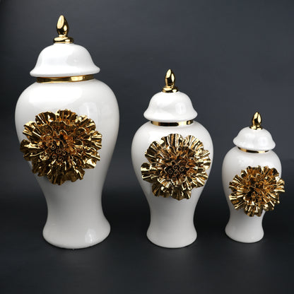 White ceramic decorative jar with gold sculpted floral design and lid