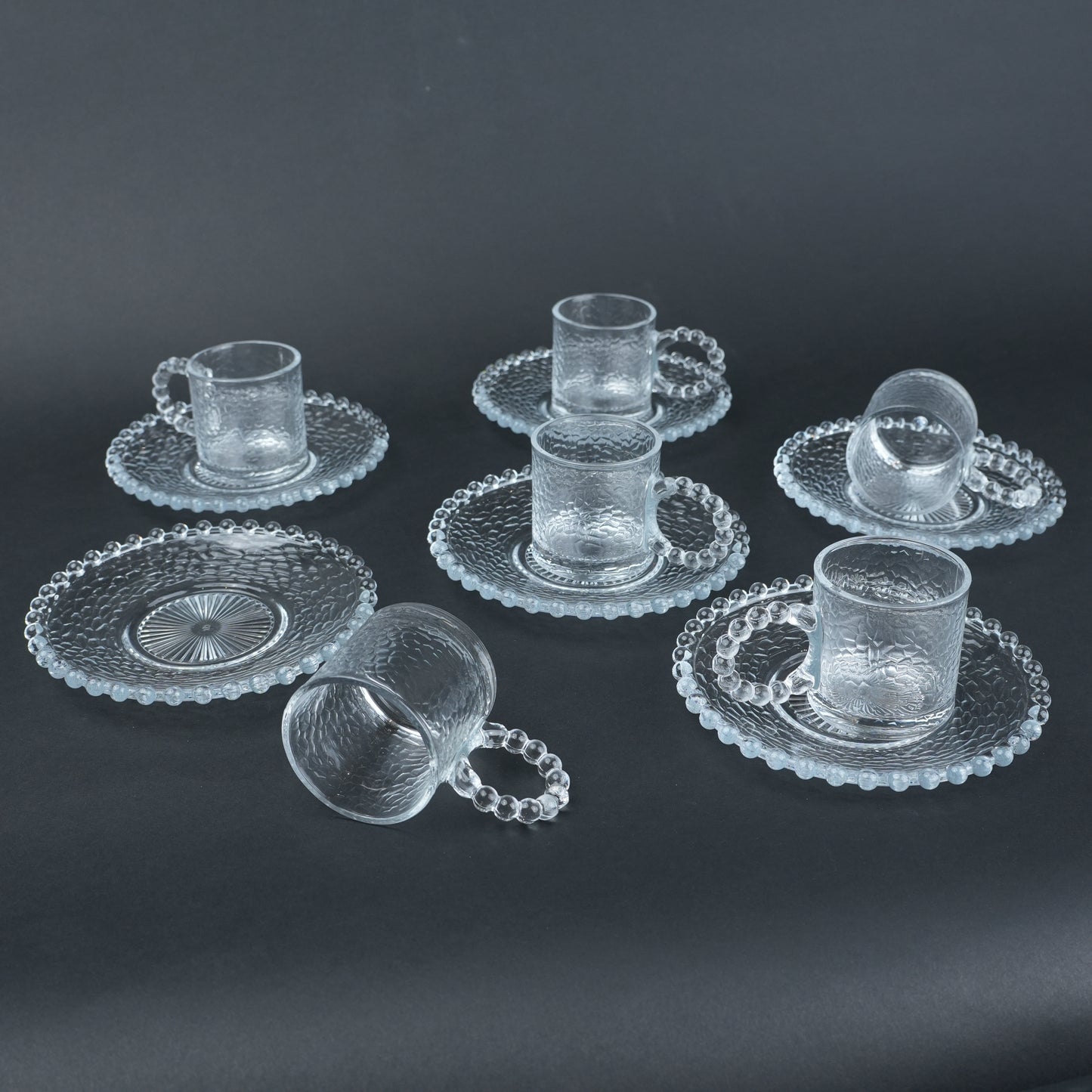 beaded glass tea cup and saucer set available in amber and clear textured glass for modern table setting
