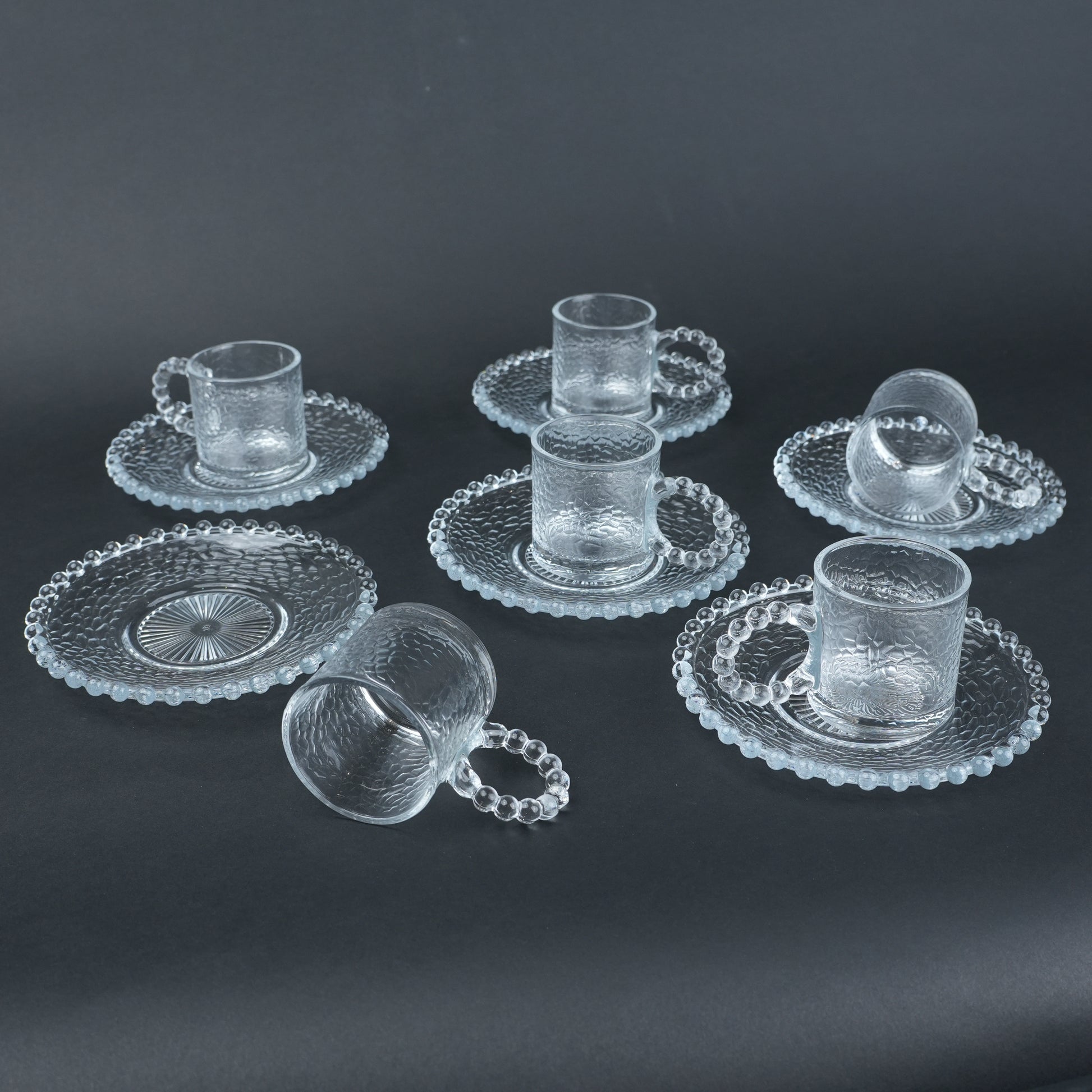 beaded glass tea cup and saucer set available in amber and clear textured glass for modern table setting