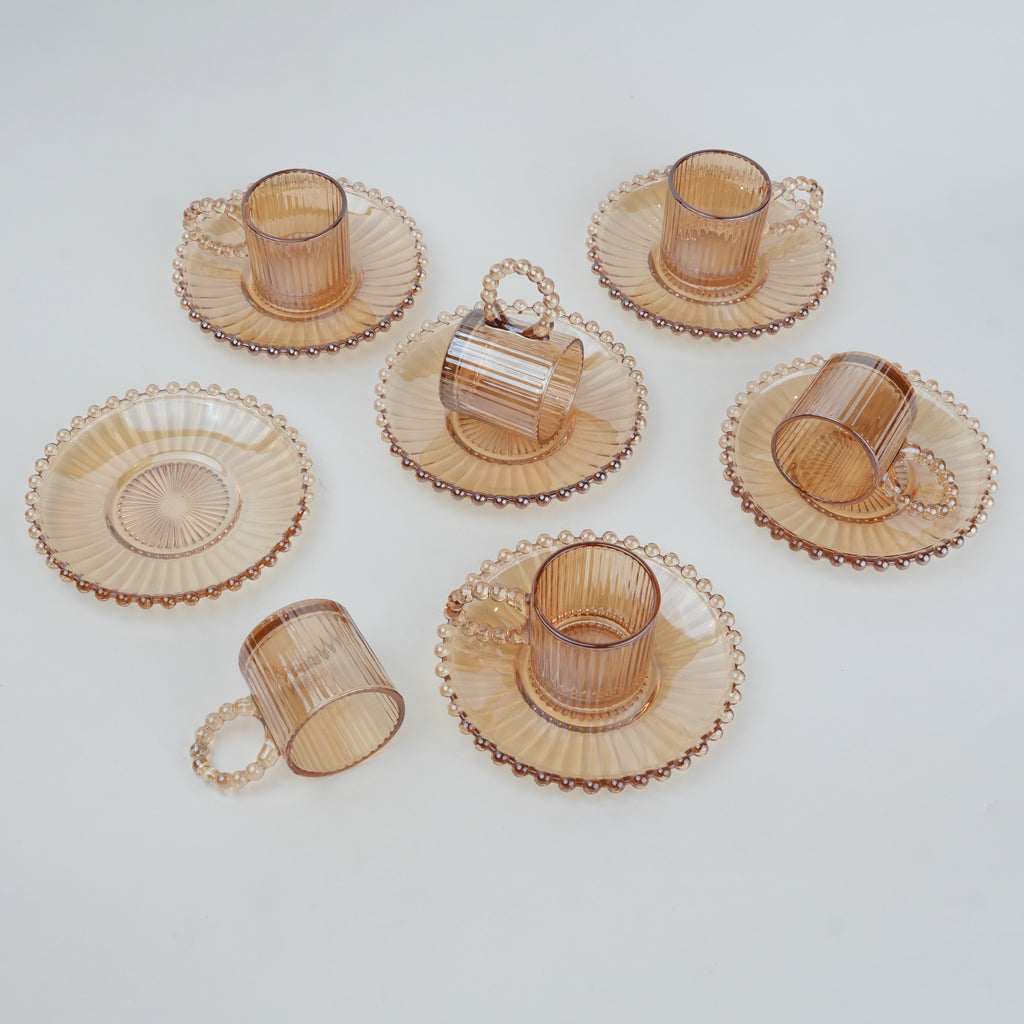 beaded glass tea cup and saucer set available in amber and clear textured glass for modern table setting