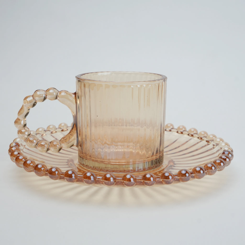 beaded glass tea cup and saucer set available in amber and clear textured glass for modern table setting
