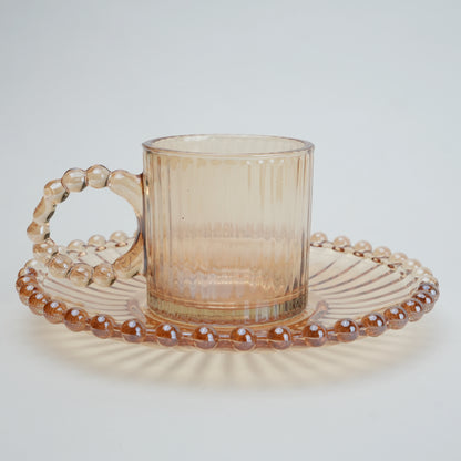 beaded glass tea cup and saucer set available in amber and clear textured glass for modern table setting