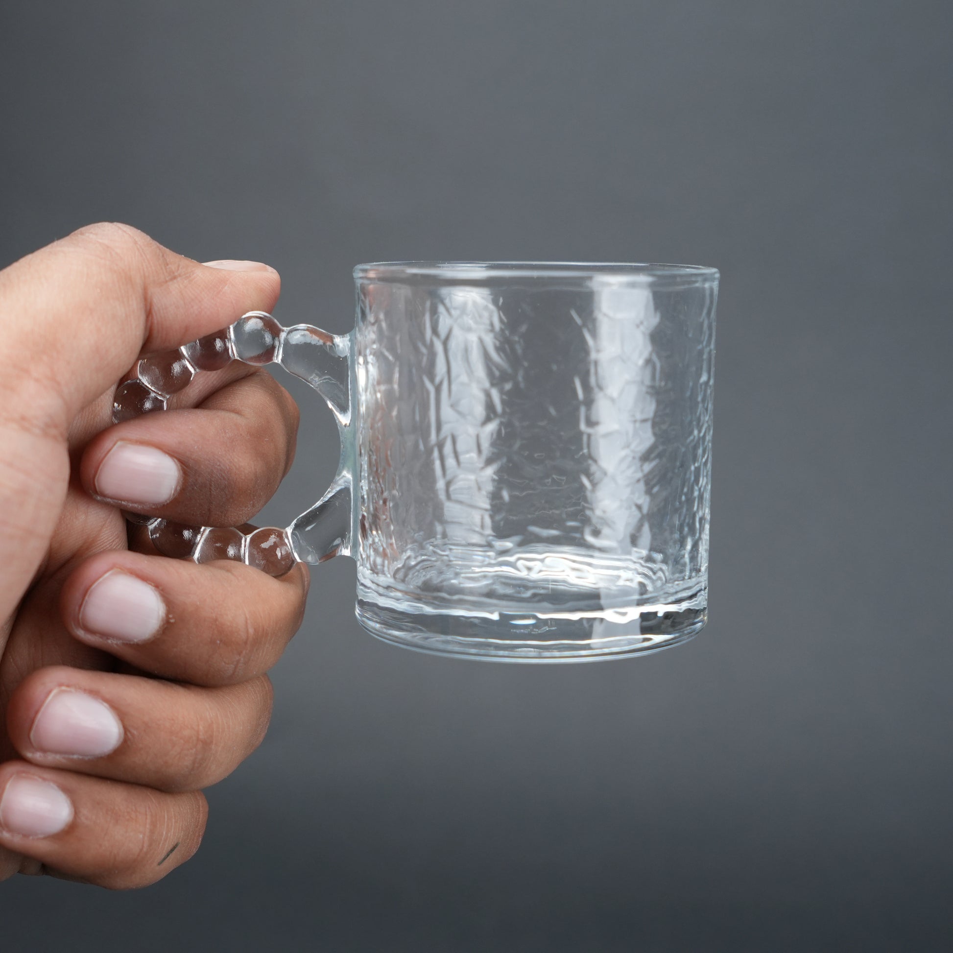 beaded glass tea cup and saucer set available in amber and clear textured glass for modern table setting