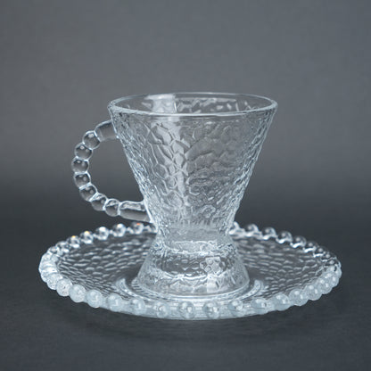clear textured glass flared tea cup and saucer set with beaded handle for modern table setting