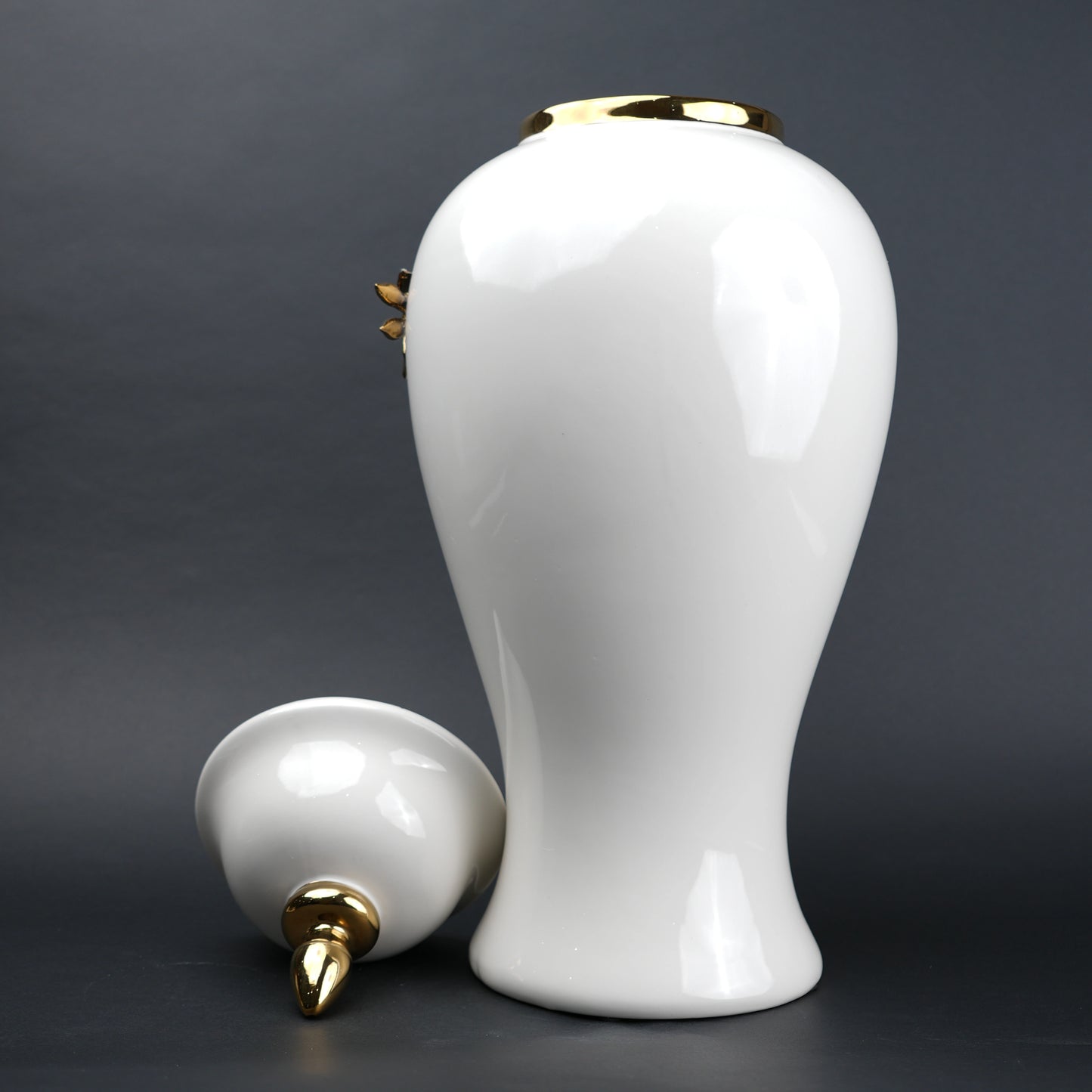 White ceramic decorative jar with gold cascading leaf design and lid