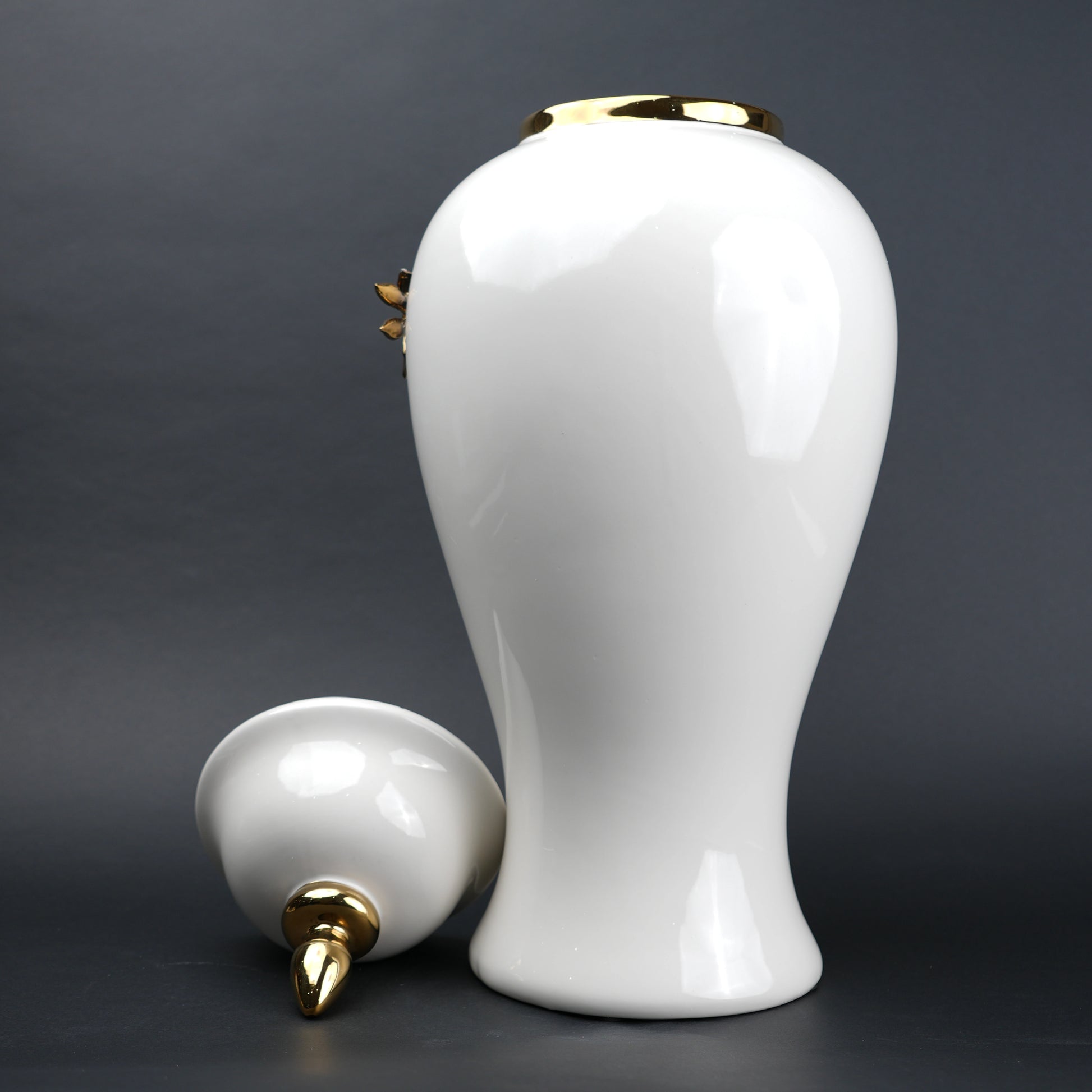 White ceramic decorative jar with gold cascading leaf design and lid