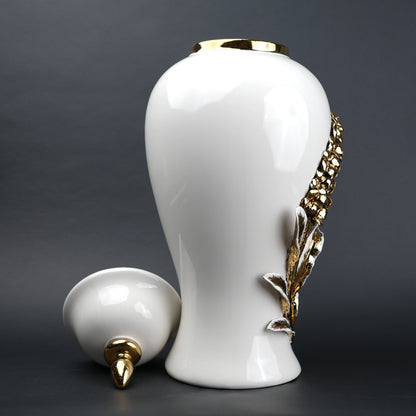 White ceramic decorative jar with gold cascading leaf design and lid