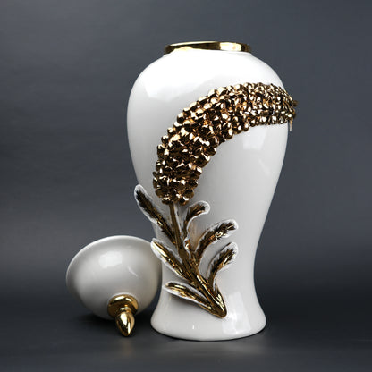 White ceramic decorative jar with gold cascading leaf design and lid