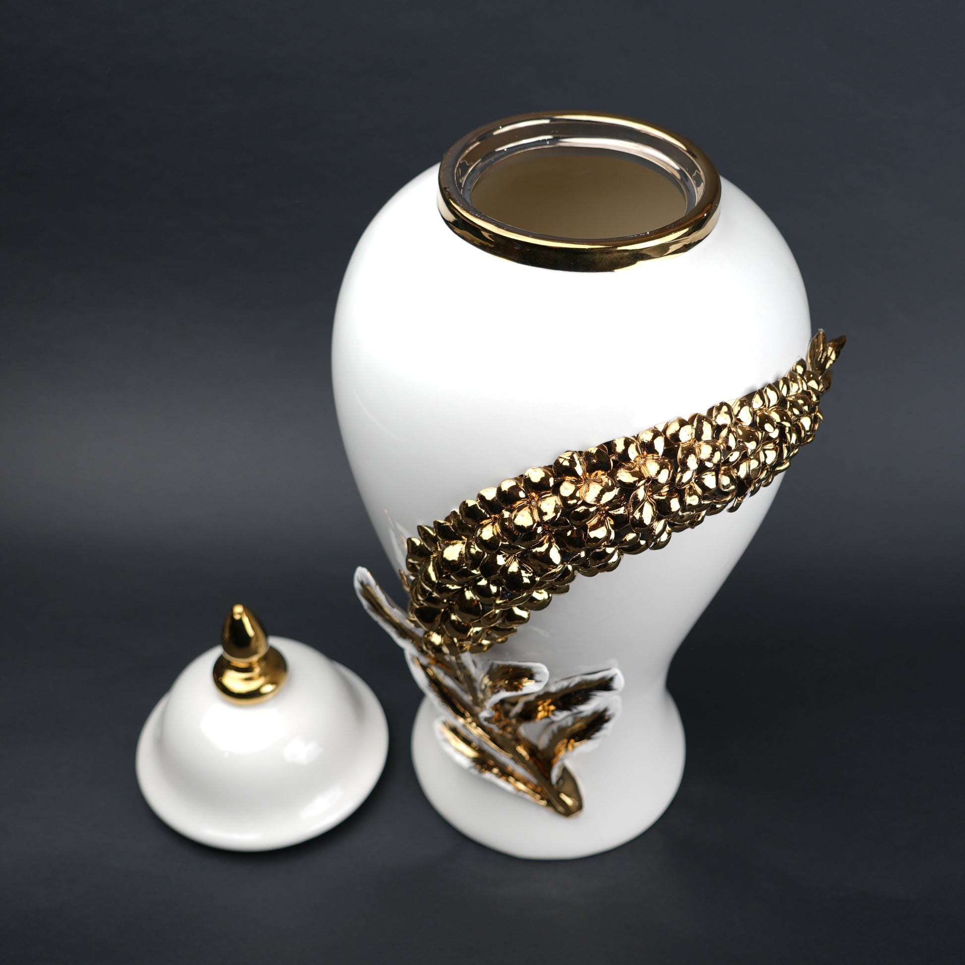 White ceramic decorative jar with gold cascading leaf design and lid