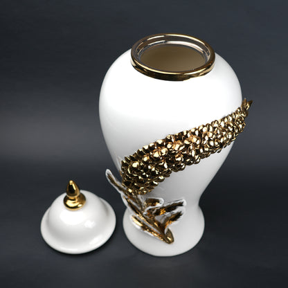 White ceramic decorative jar with gold cascading leaf design and lid