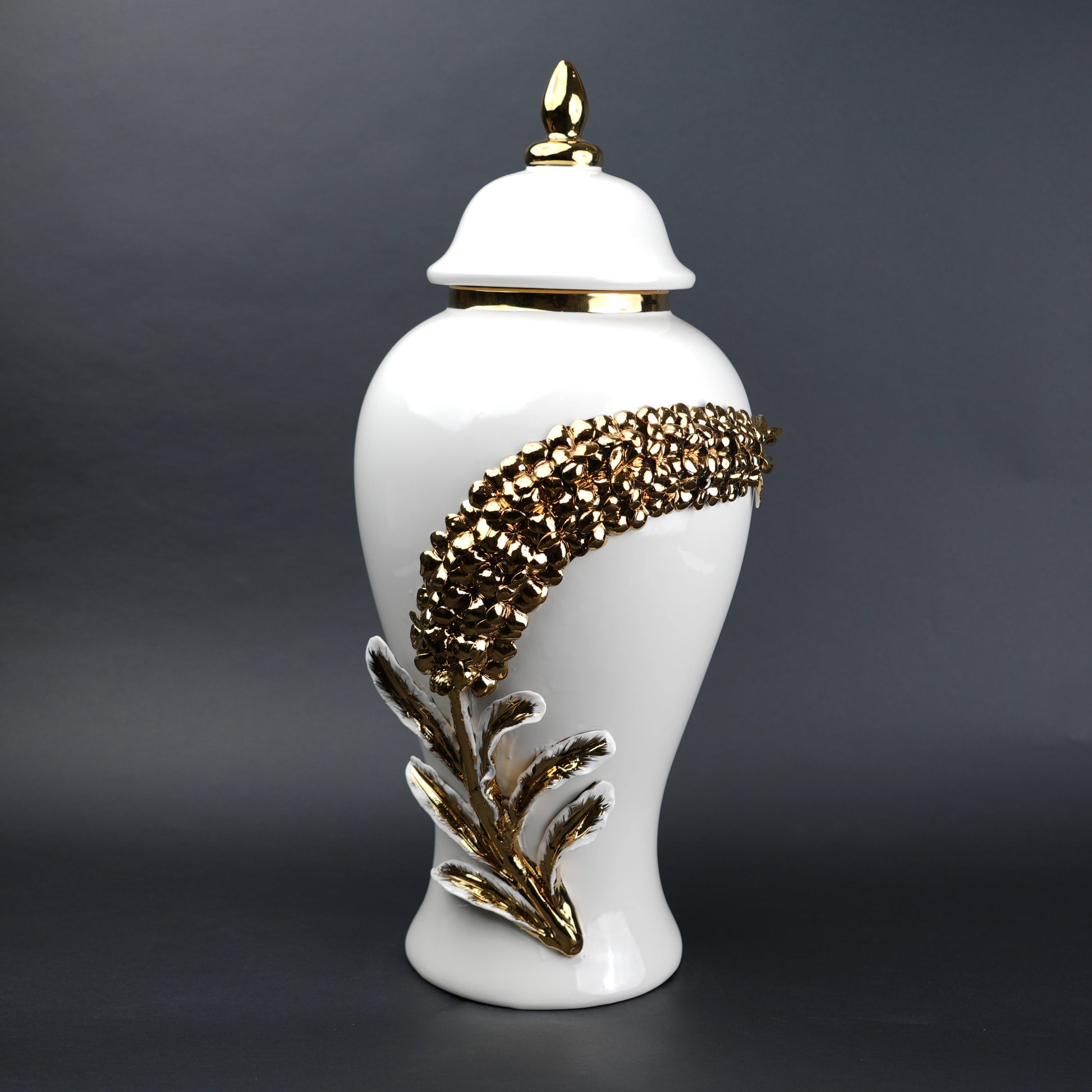 White ceramic decorative jar with gold cascading leaf design and lid
