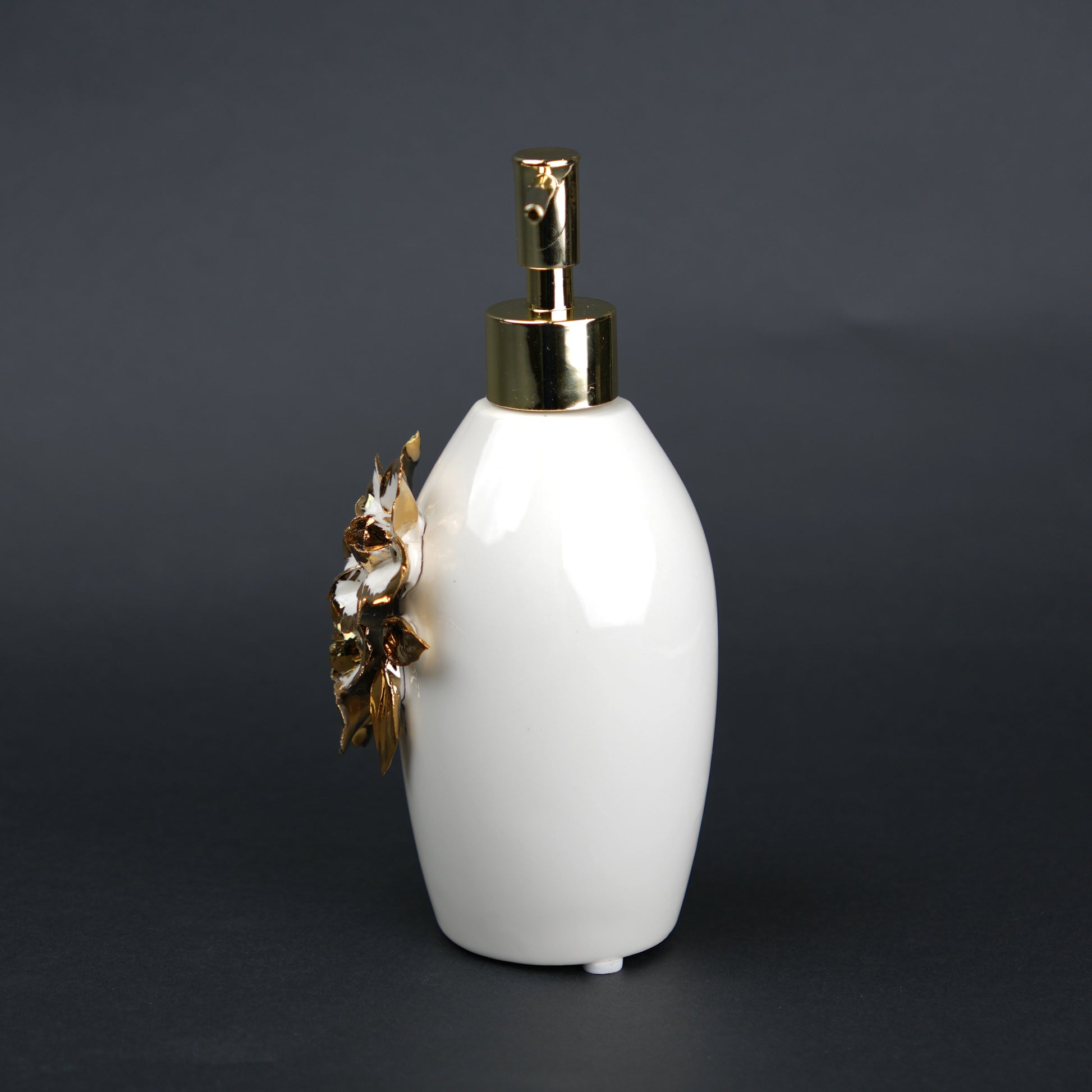 Ivory ceramic soap dispenser with gold floral detailing and metallic pump