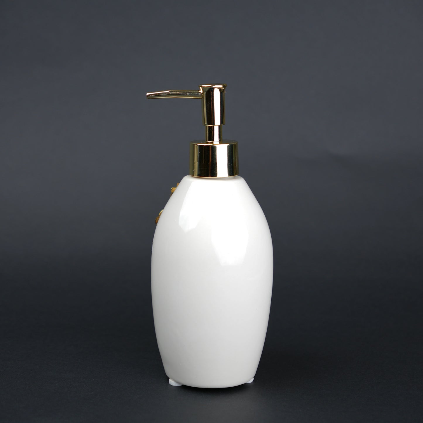 Ivory ceramic soap dispenser with gold floral detailing and metallic pump