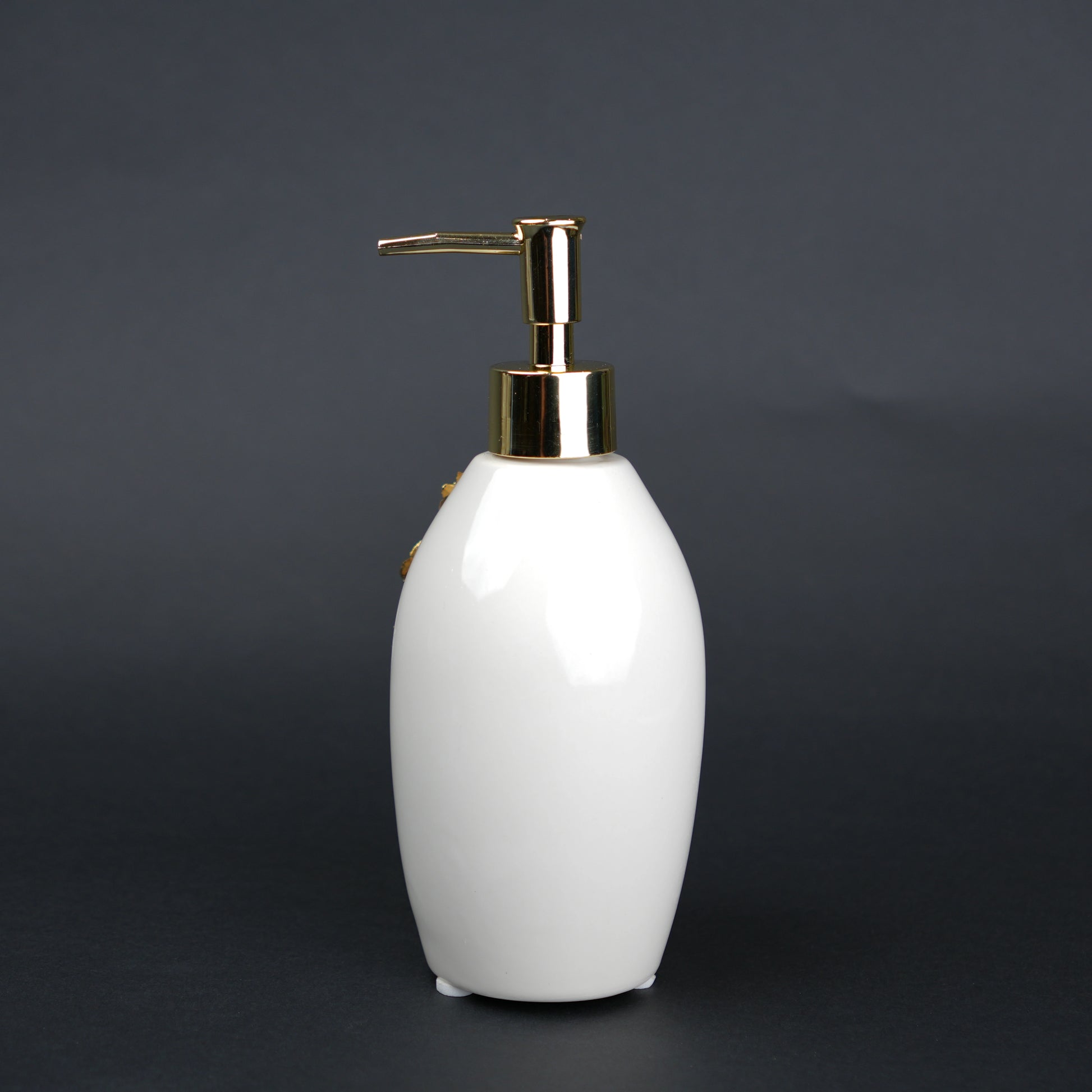 Ivory ceramic soap dispenser with gold floral detailing and metallic pump