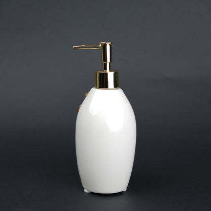 Ivory ceramic soap dispenser with gold floral detailing and metallic pump