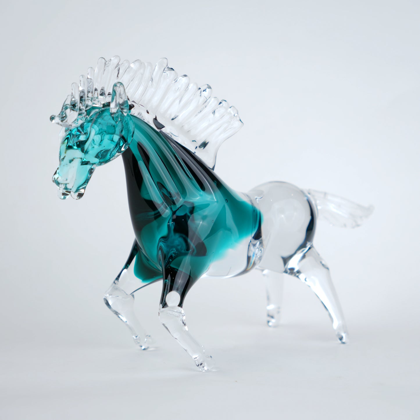 Aqua teal glass horse figurine with clear glass body and textured mane detail