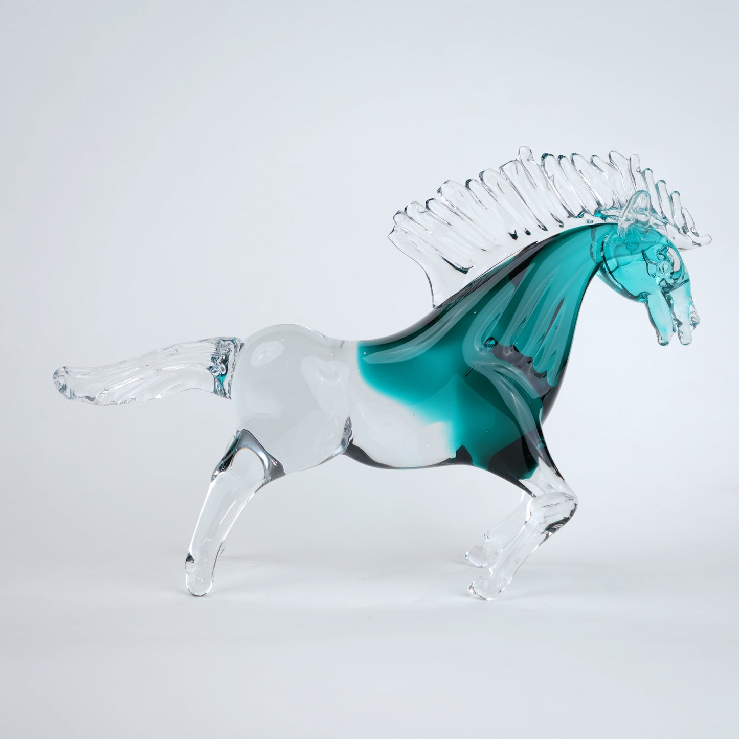 Aqua teal glass horse figurine with clear glass body and textured mane detail