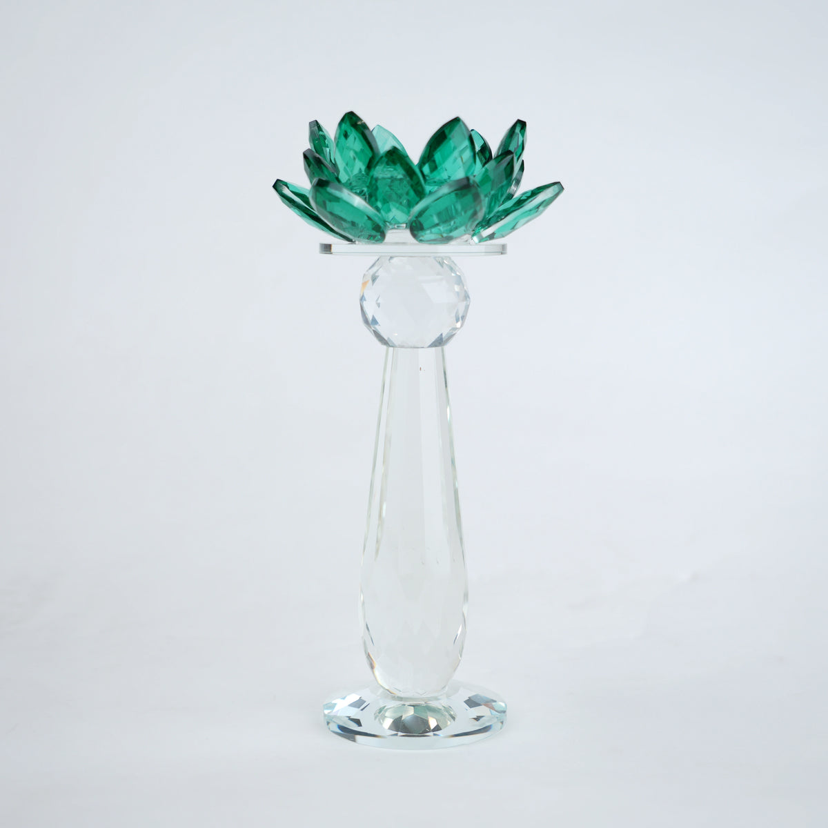 Emerald green glass lotus candle holder with faceted petals and clear crystal base