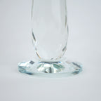 Emerald green glass lotus candle holder with faceted petals and clear crystal base