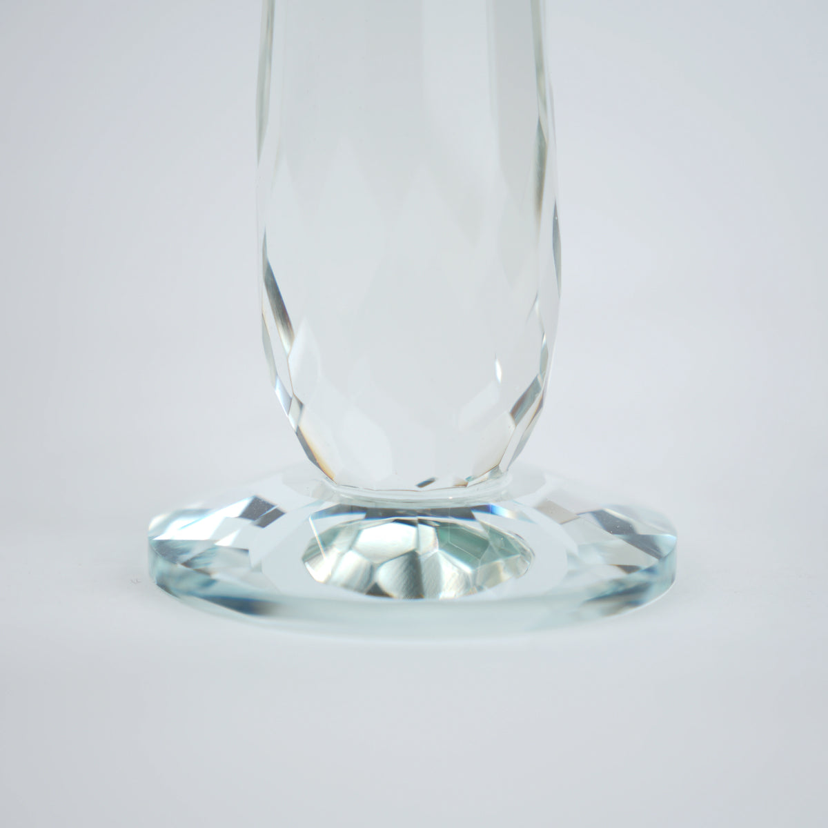 Emerald green glass lotus candle holder with faceted petals and clear crystal base
