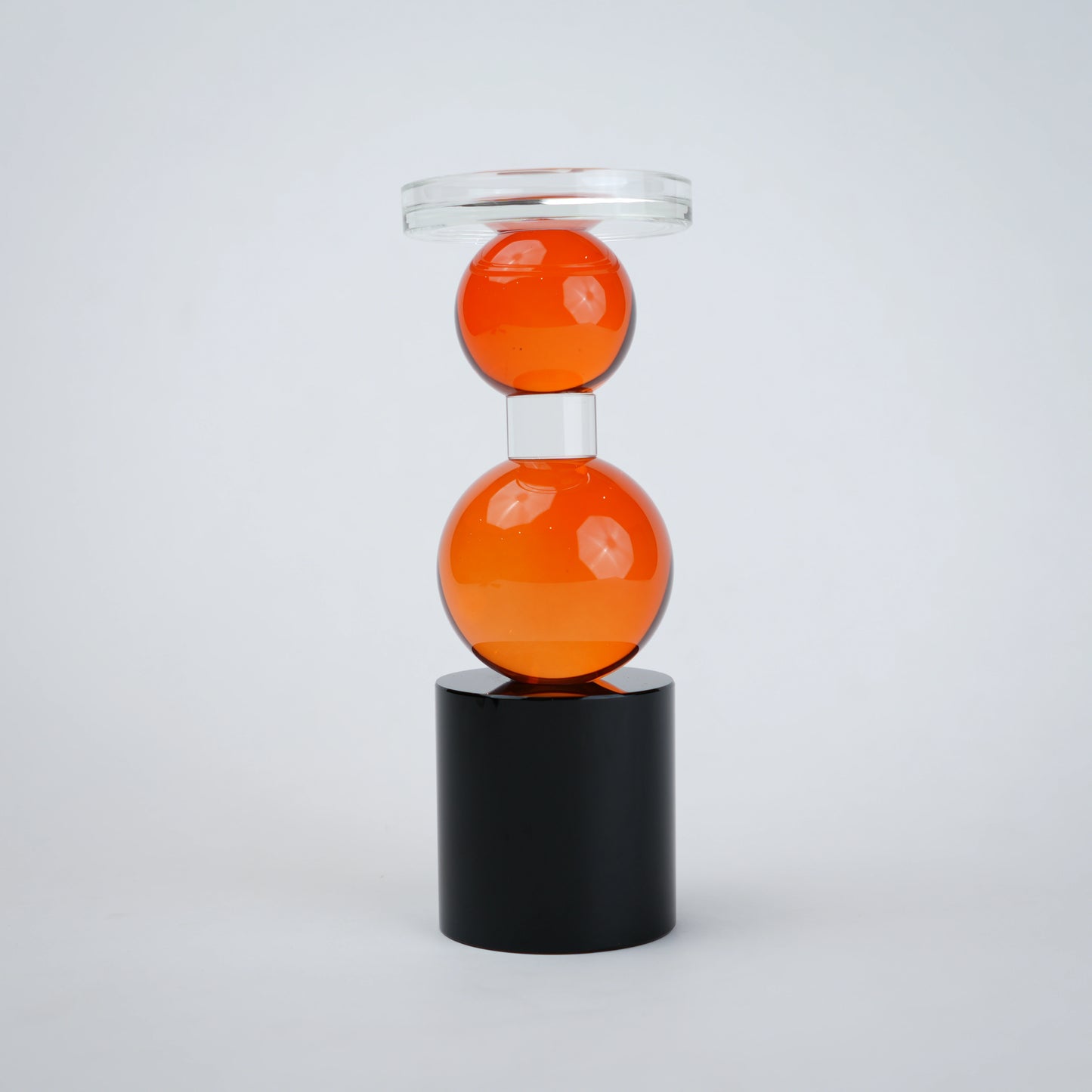 amber glass orb candle holder with black base modern decor