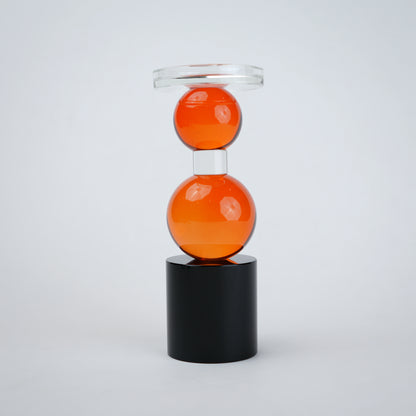 amber glass orb candle holder with black base modern decor