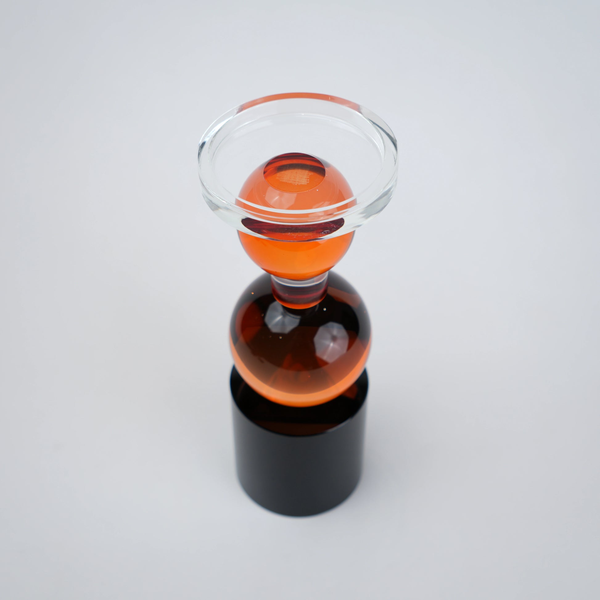 amber glass orb candle holder with black base modern decor