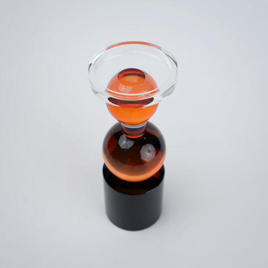 amber glass orb candle holder with black base modern decor