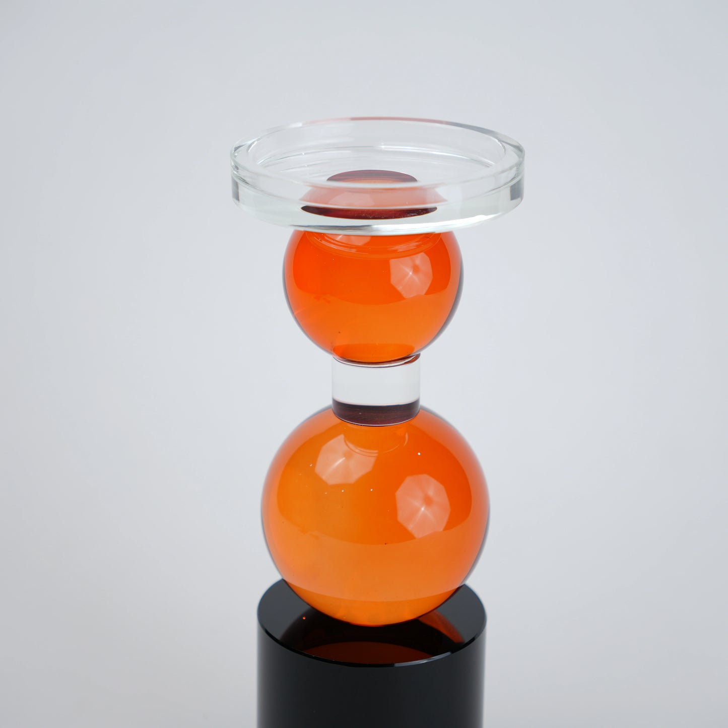 amber glass orb candle holder with black base modern decor