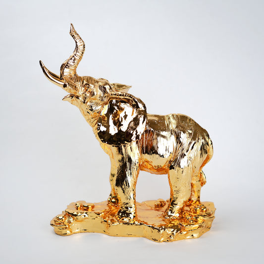 Gold elephant figurine on a white background