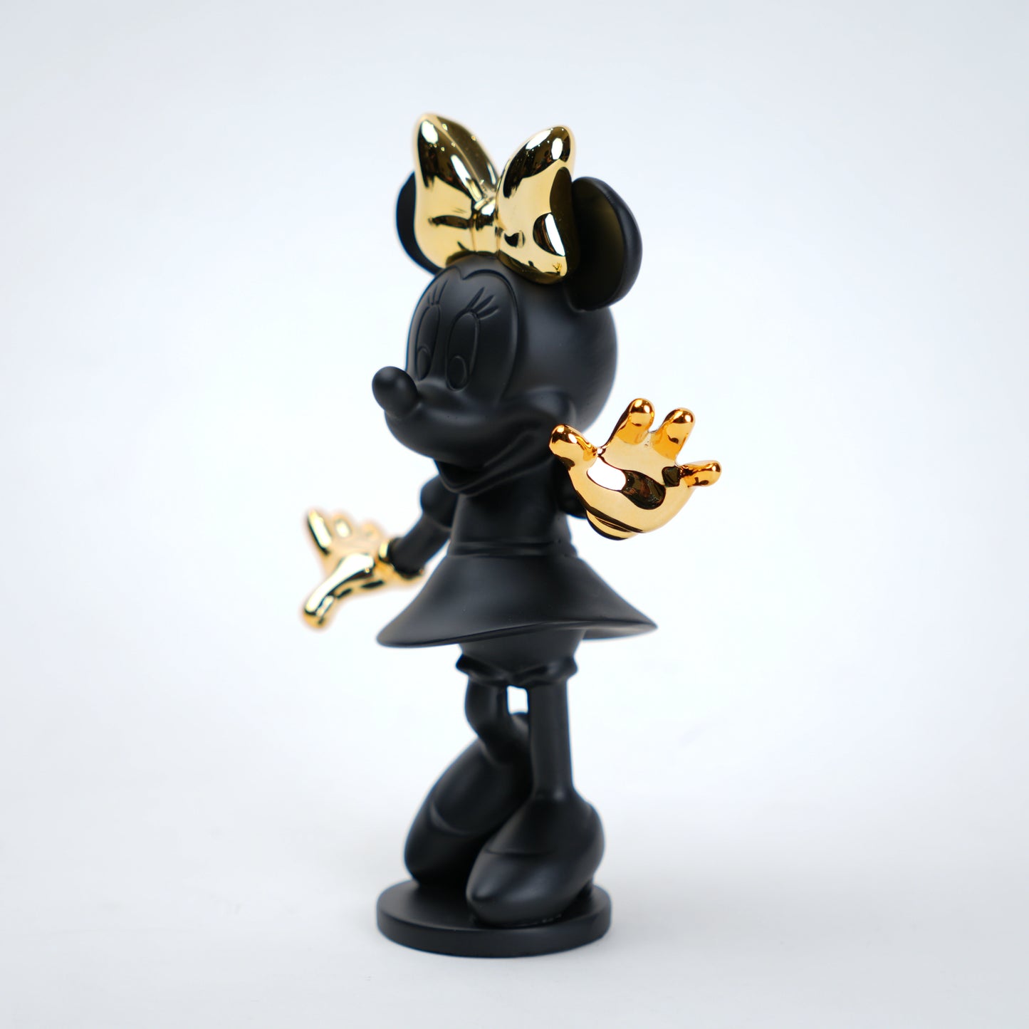 Black and gold character figurine on a white background