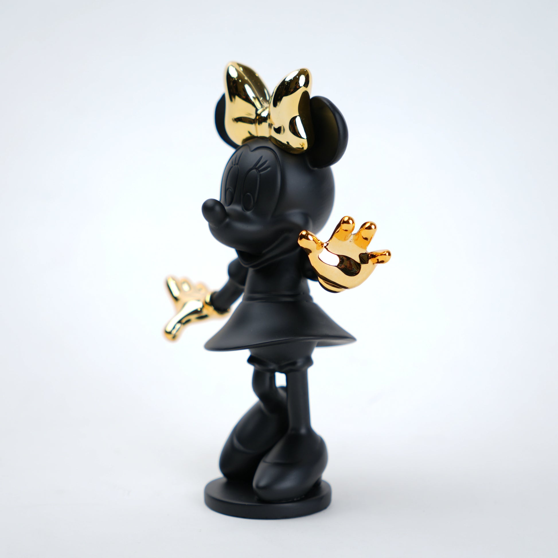 Black and gold character figurine on a white background