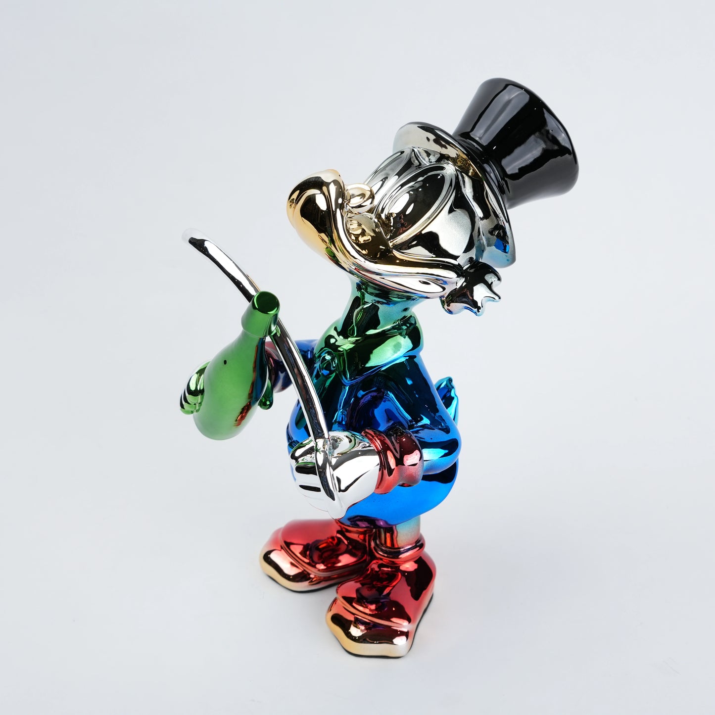 Colorful figurine of a character with a top hat and cane on a light gray background