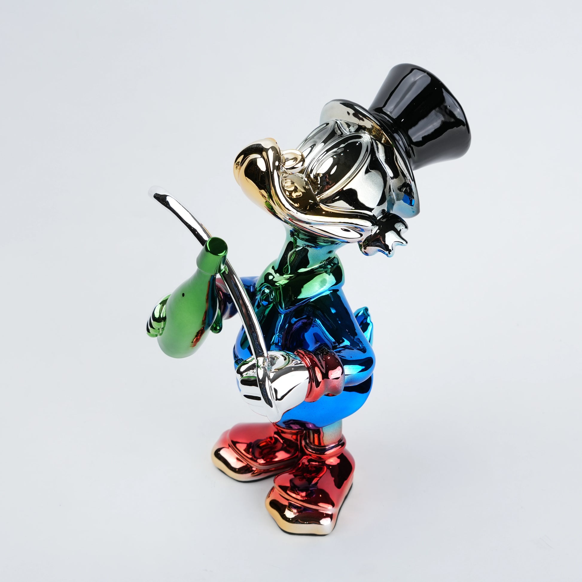 Colorful figurine of a character with a top hat and cane on a light gray background