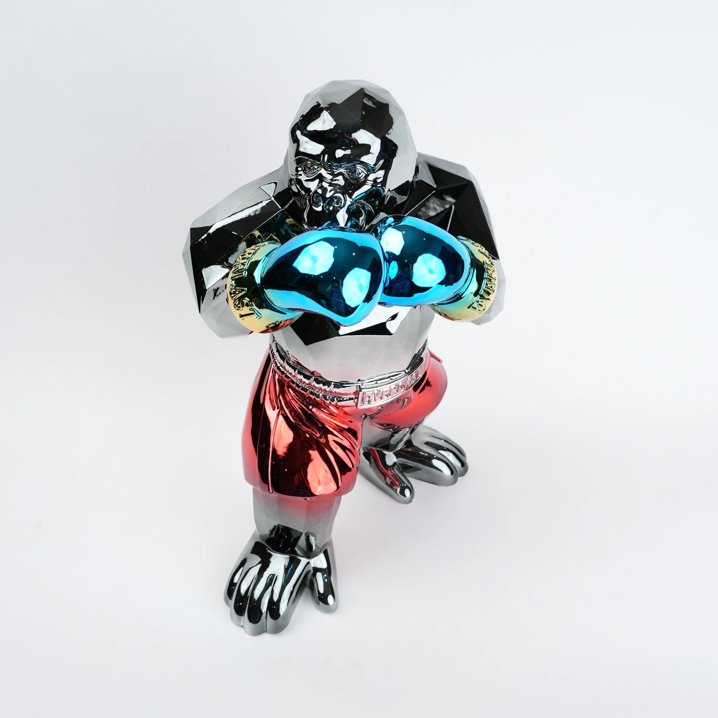 Metallic figurine with glowing blue eyes on a white background