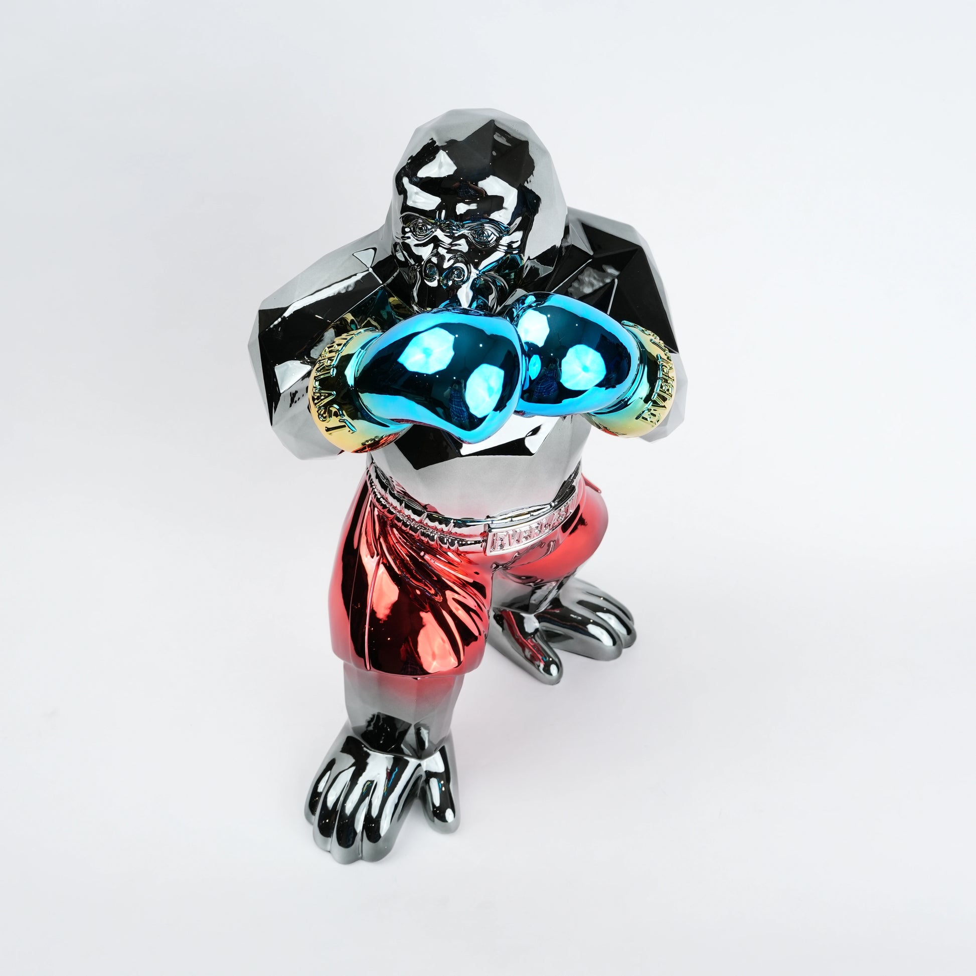 Metallic figurine with glowing blue eyes on a white background