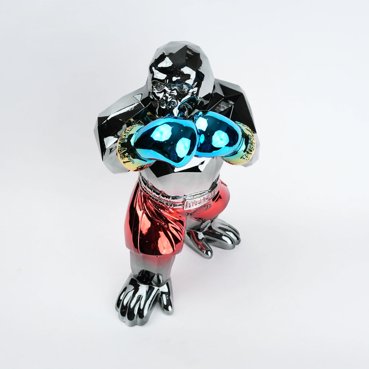 Metallic figurine with glowing blue eyes on a white background