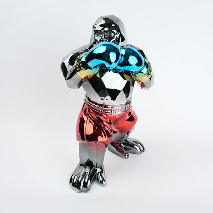 Electroplated resin gorilla boxer figurine in a strong upright stance with raised boxing gloves, featuring a reflective multicolor metallic finish, detailed muscular form, and smooth high-gloss surface designed as a bold modern decor piece.